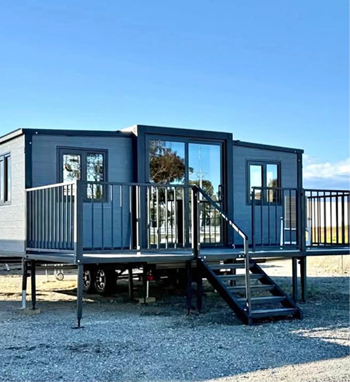 Expandable container home exterior on a prepared site